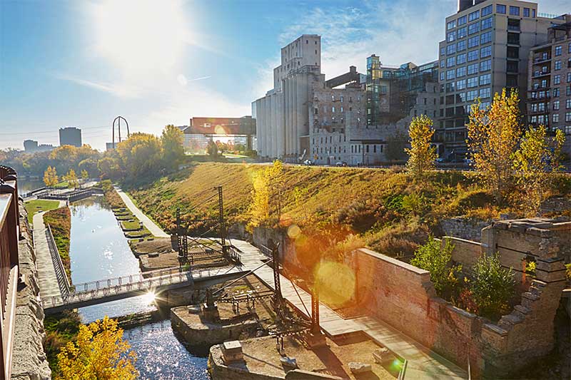 A photograph to represent Minnesota, featuring a Minneapolis lock in front of tall city buildings.