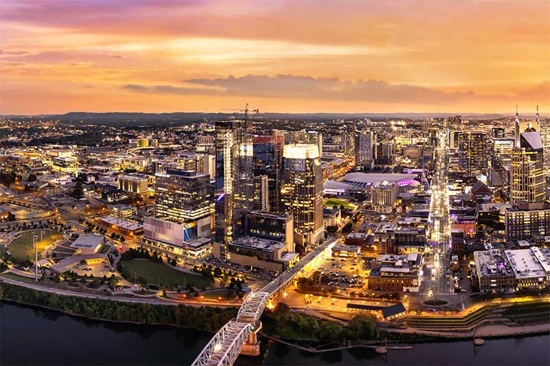 A photograph to represent Nashville, featuring an aerial view of the city as night approaches.